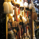 Interesting brooms and brushes, Chinese parasols, hand-painted fans and all sorts of purses, jewelry and souvenirs were attractively displayed.