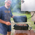 By turning the bar sideways and using a couple of wing nut bolts, a table for our Weber Go-Anywhere BBQ is conveniently right below the quick-disconnect LP valve.