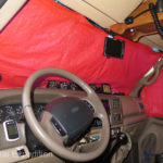 We fabricated door and windshield covers from Space Blanket material bought at REI. They fold easily and are stored above the sun visor.