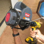 The 198-pound tire and wheel are easily lowered using a draw bar that fits a socket on the roof. A 500-lb capacity Warn Drill Winch lowers the tire to the ground.