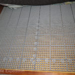 Under the lower mattress we added plastic waffle mats to prevent moisture created by body heat on a cold surface.