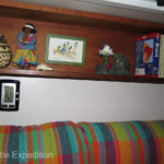 The shelf above the bed is a good place for books and a few knickknacks that make the camper feel like home, even for a one night stop.