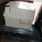 The toilet slides out on tracks and can be moved anywhere.