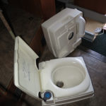 The top separates from the base holding tank which can be easily carried to a location where it can be dumped.