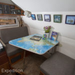 Our dinette table can sit four in a pinch, but it was sized and designed for two adults and it does not make into a bed.